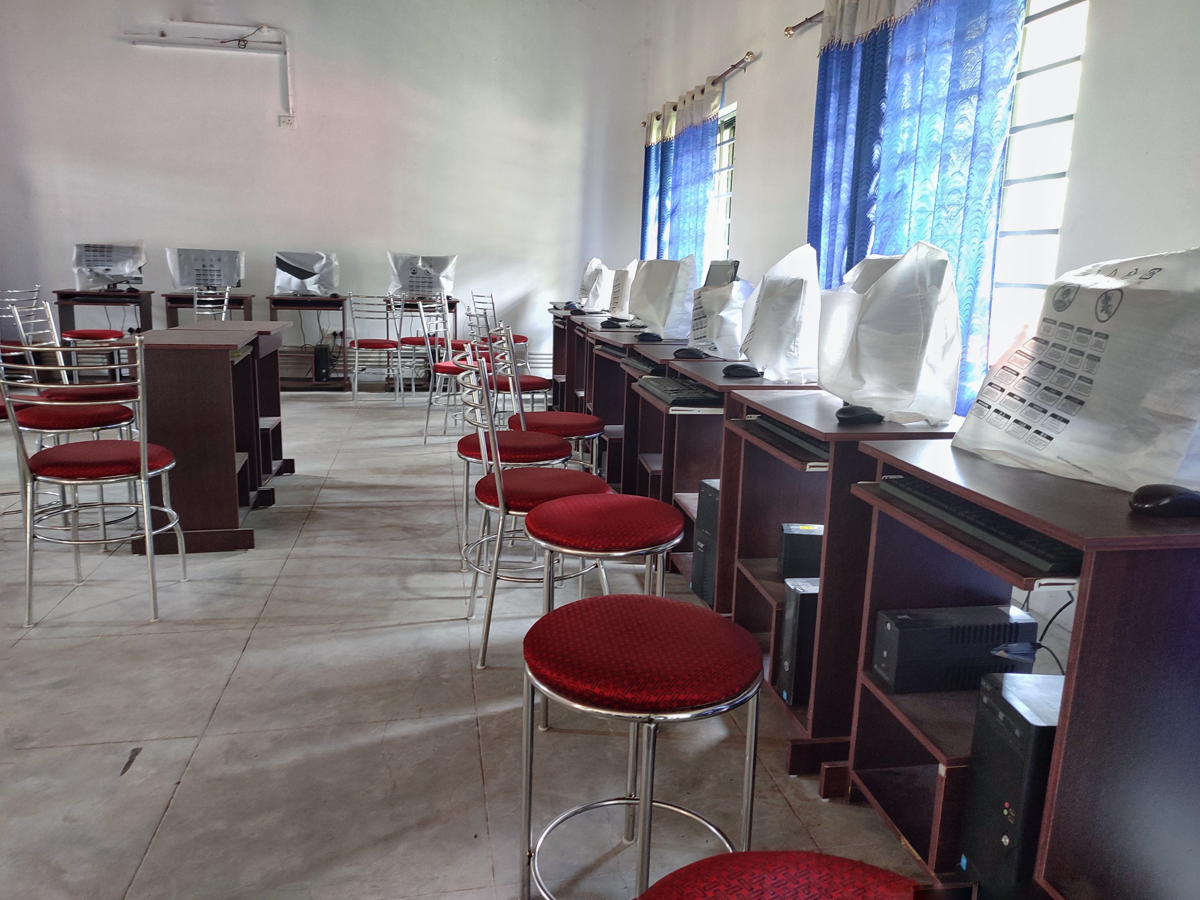 compter lab with computers arranged along the wall on independent tables